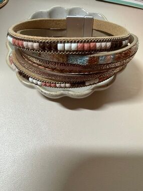Bracelet in leather strap on the bottom and is beautiful for everyday wear.
